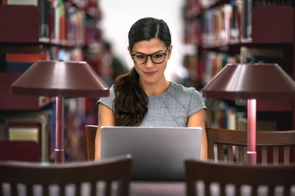 Law student in the library working on her laptop